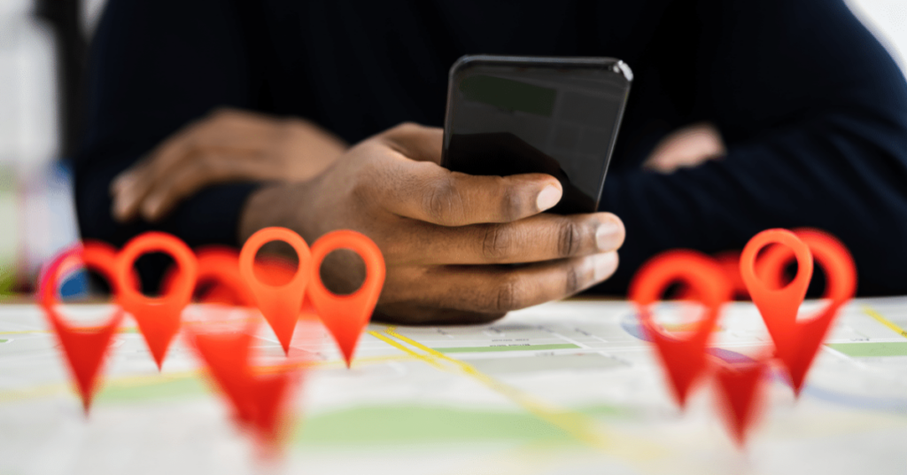 person holding phone over graphic of map